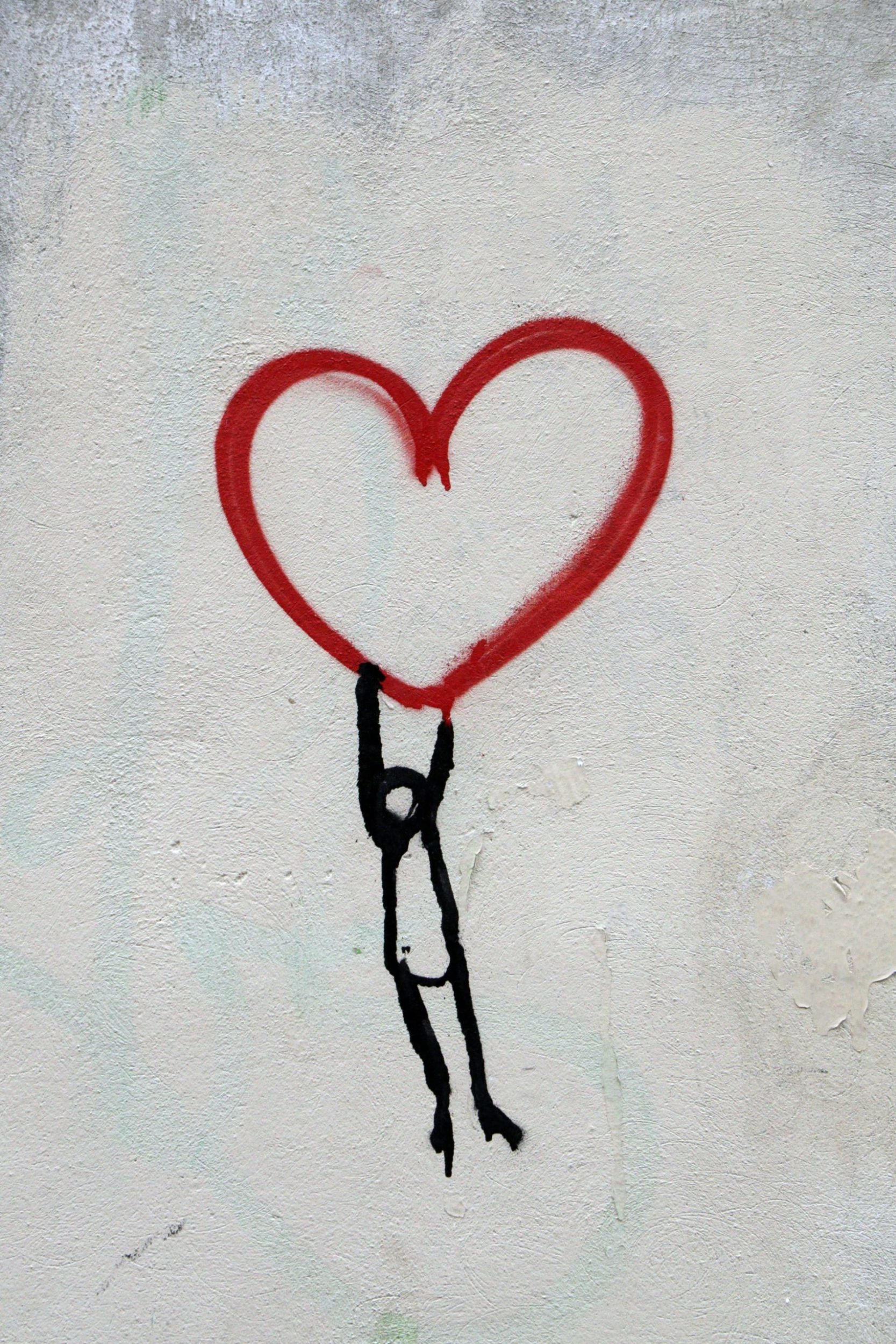 a red heart drawn on a white surface